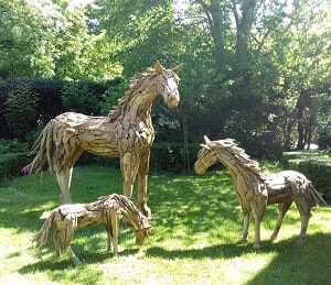 driftwood horses on grass