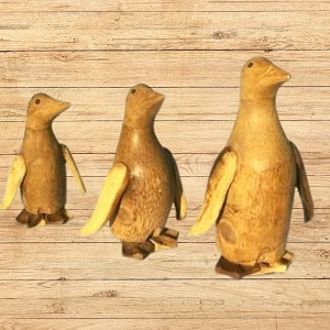 trio of wooden penguins