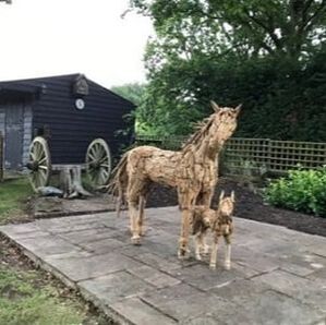 large driftwood horse and miniature driftwood horse in garden