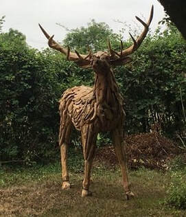 driftwood stag in a garden setting